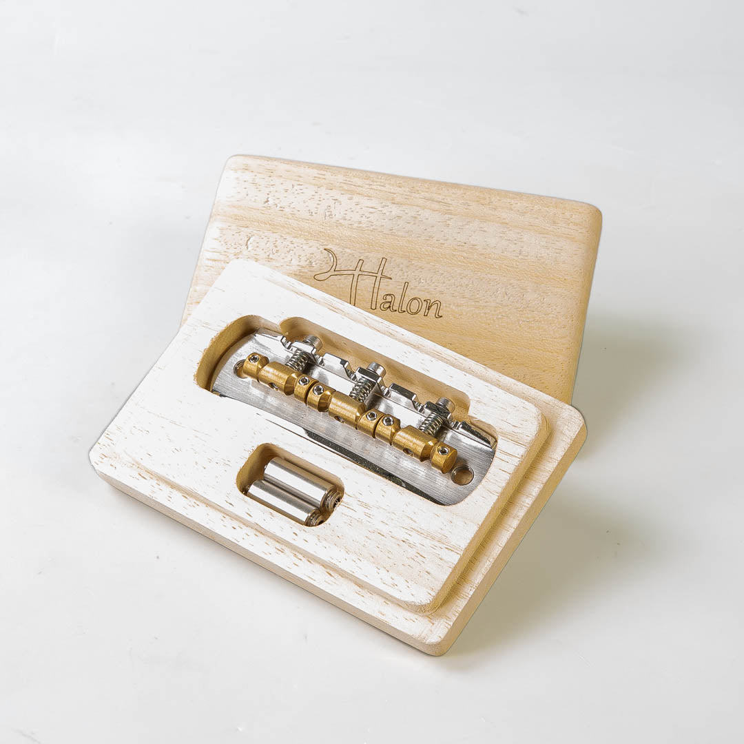 halon bass VI bridge in packaging front angled view, chrome
