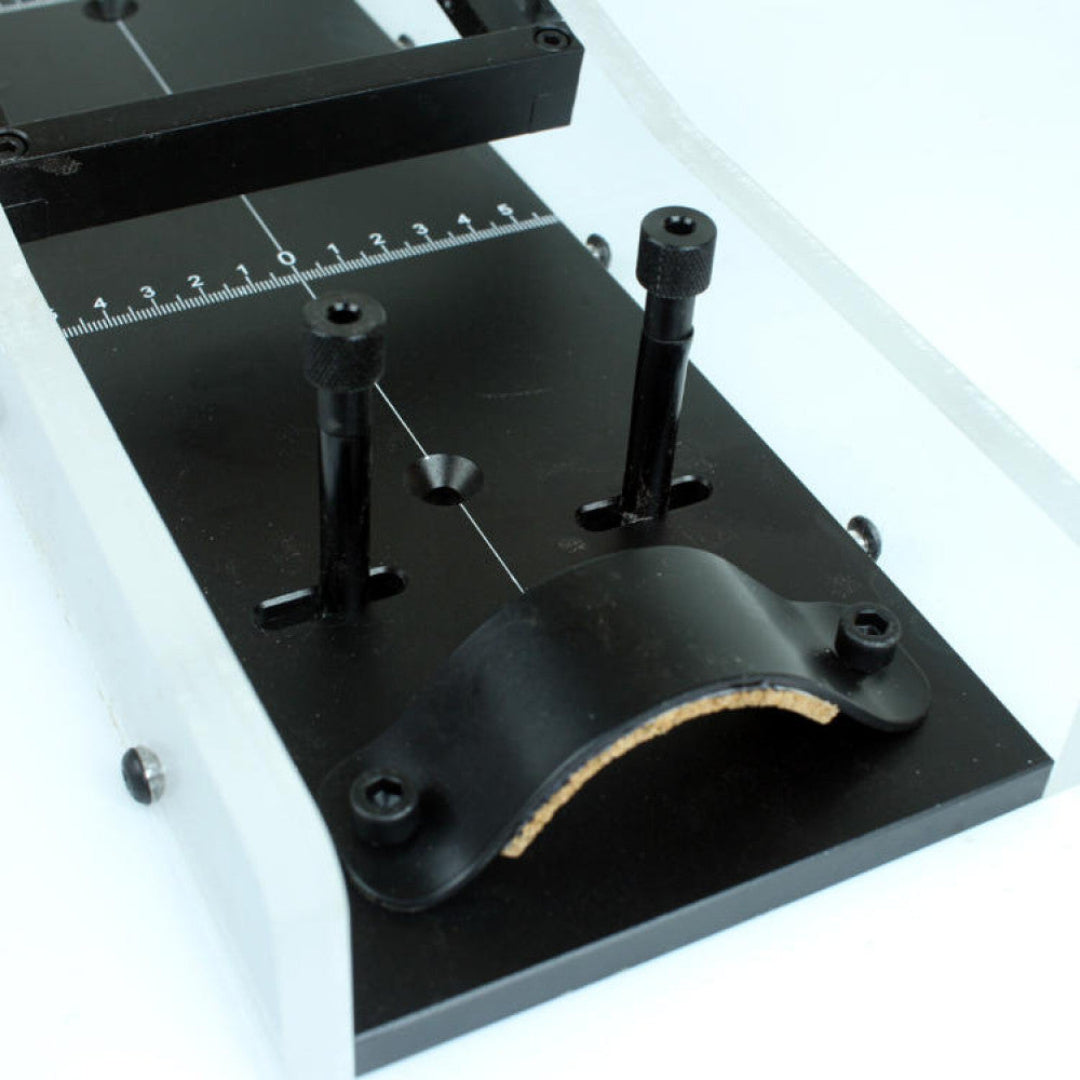 Black metal tool with adjustable components on a white background