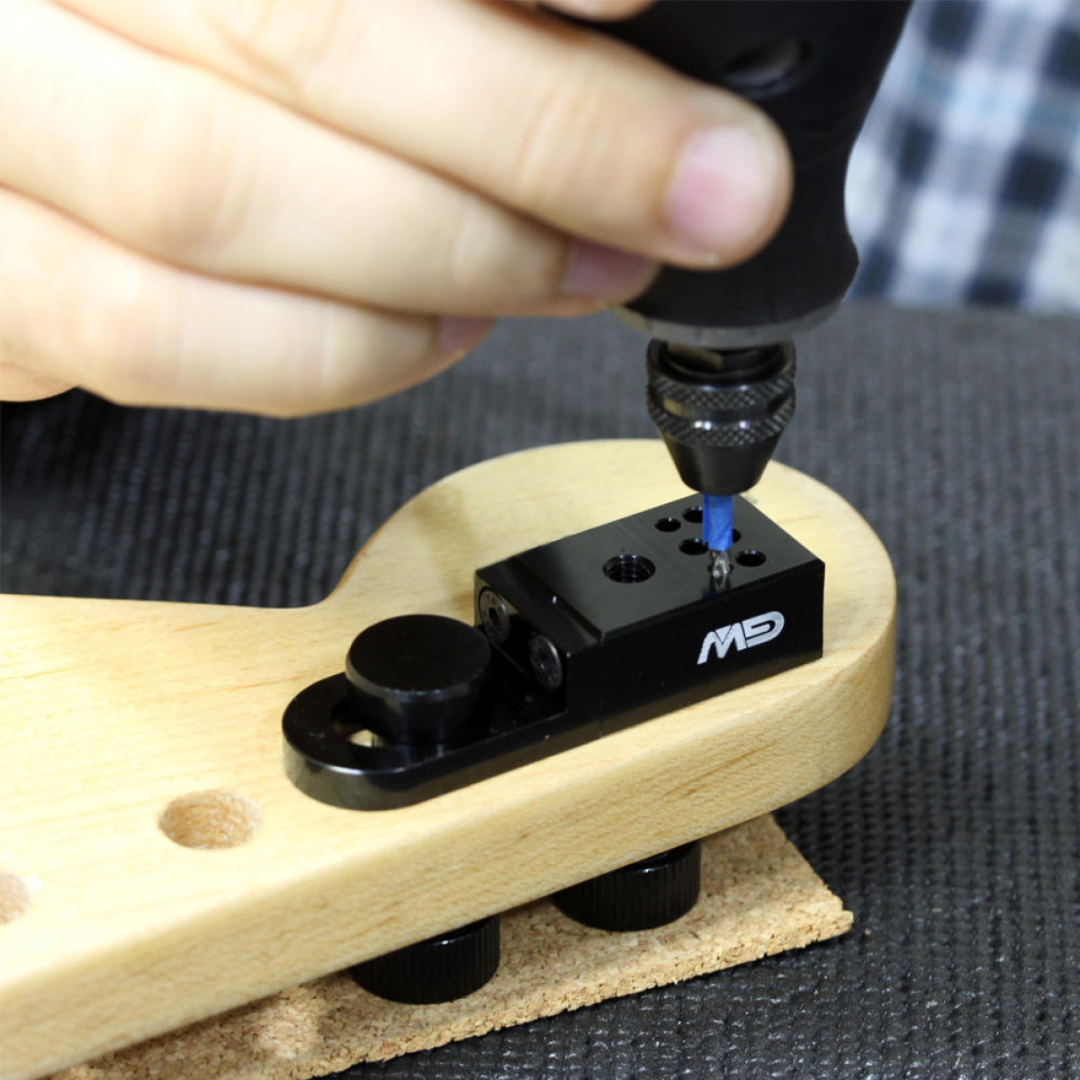 Tuner Pin Locator Jig with person screwing in the screws