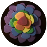 Colorful guitar picks arranged into a flower cropped into a circle