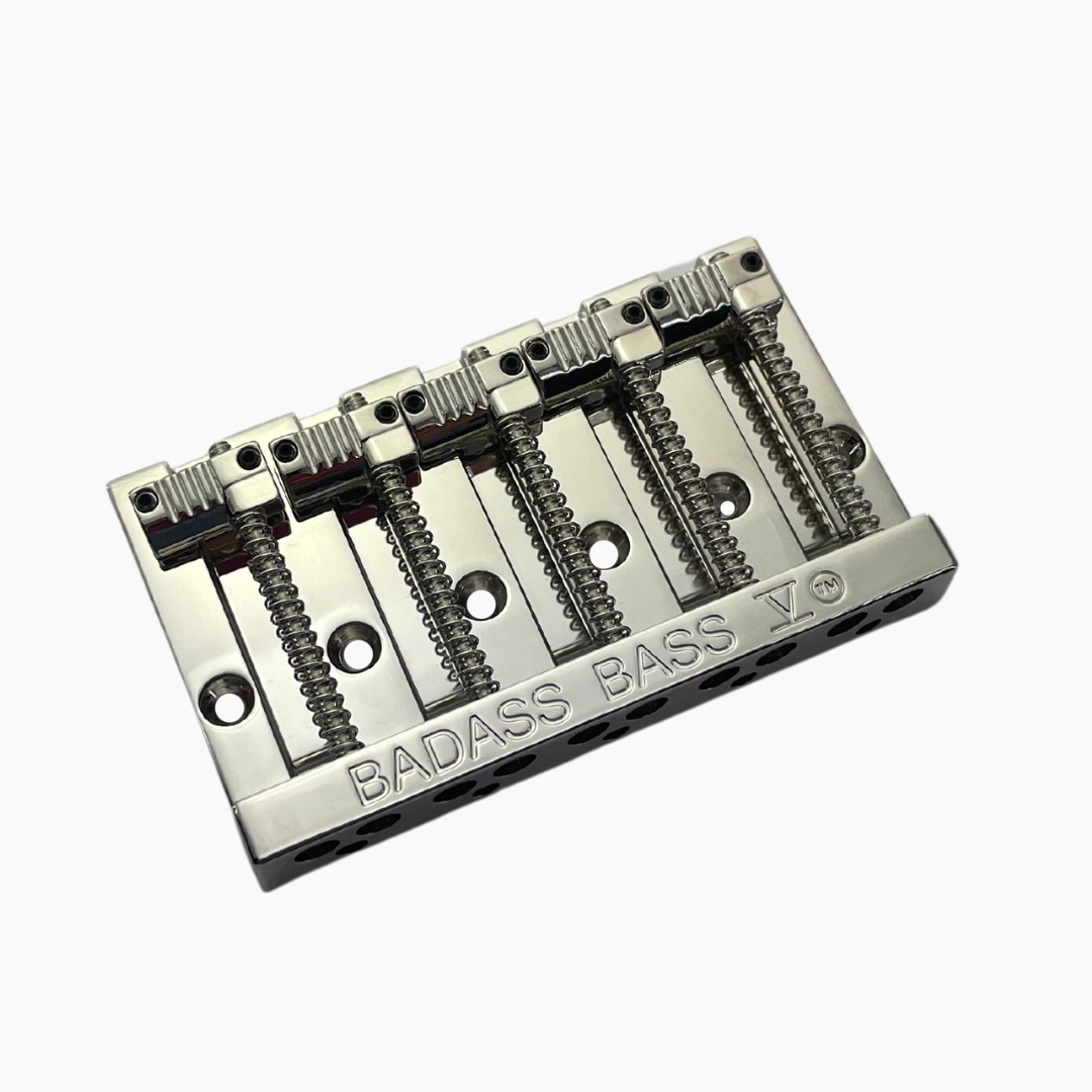 angled front view of nickel 5-string bass bridge with grooved saddles