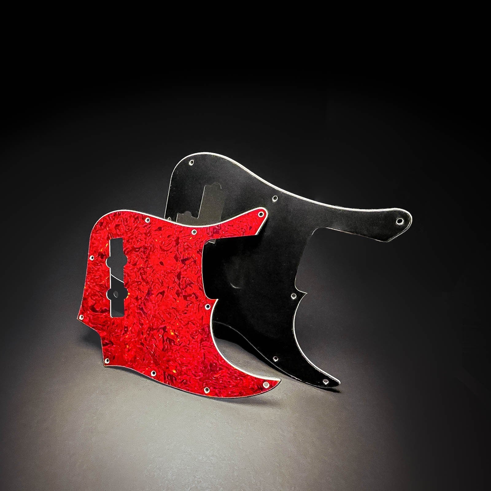 2 bass pickguards front angled view