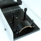 Black metal tool with adjustable components on a white background