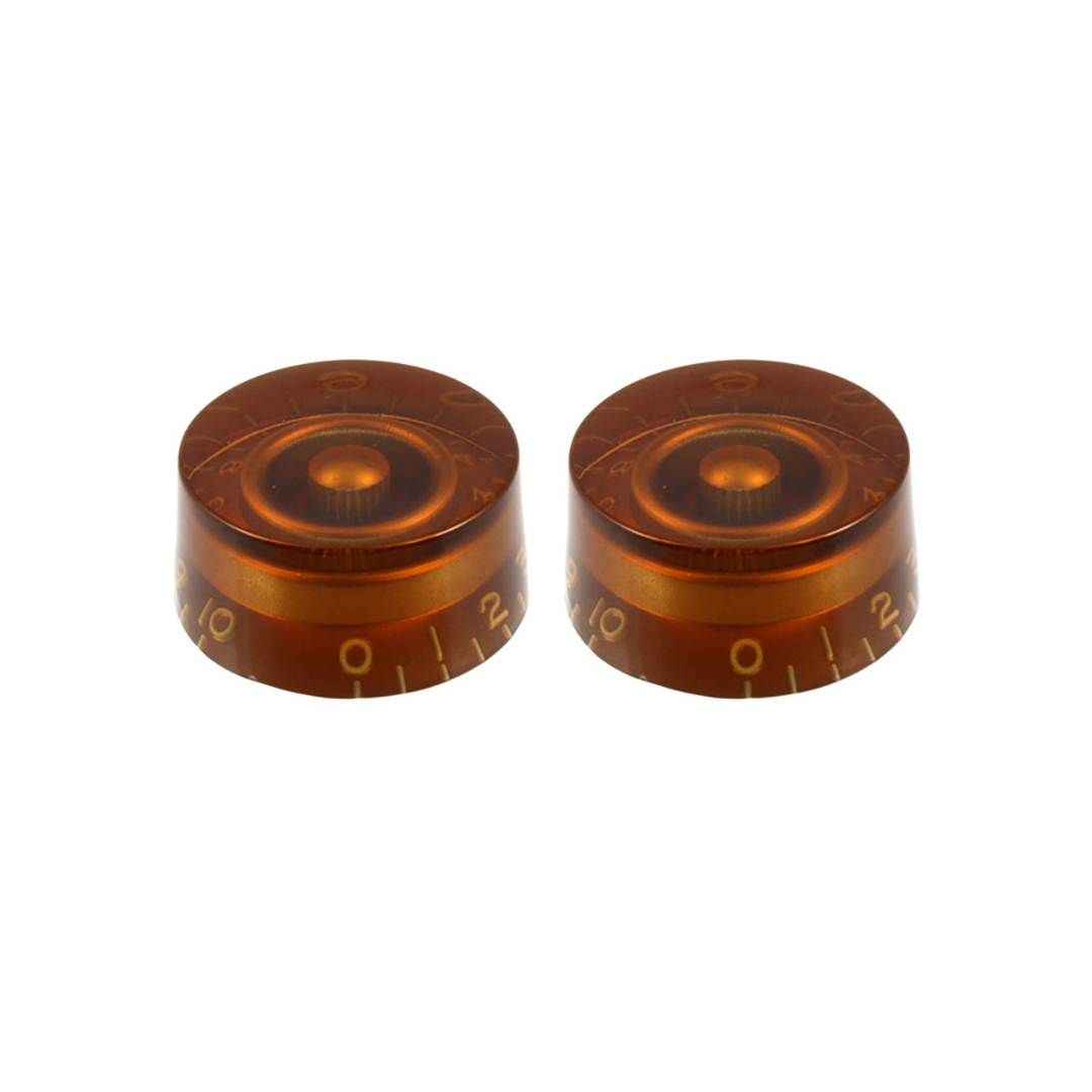 2 brownish amber colored volume knobs