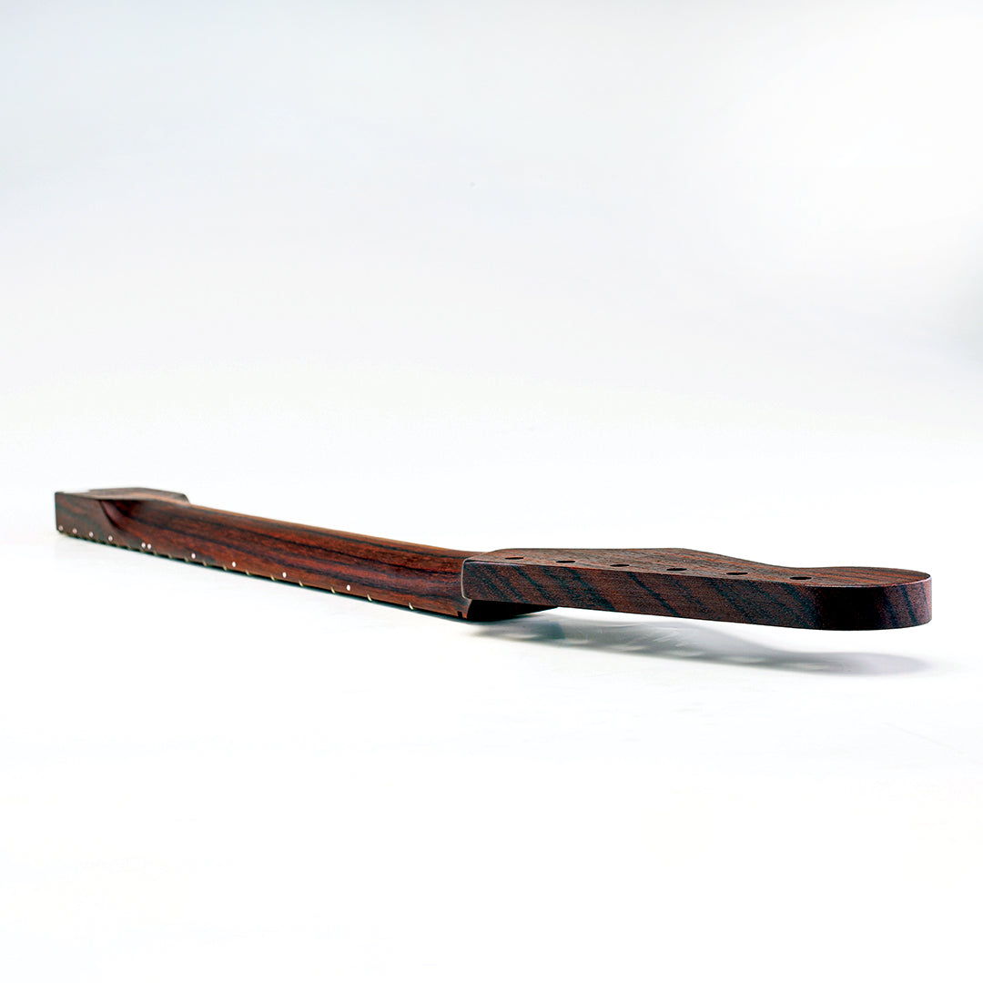 Rosewood colored guitar neck laying faced down