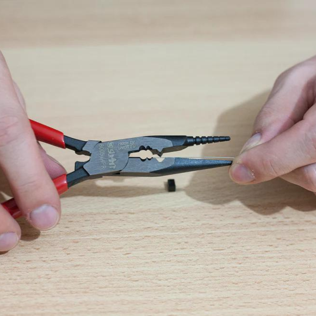 Multi-Purpose Pliers being used to cut a guitar string