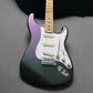 Electric guitar with a gradient purple to black finish on a gray background