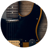 Close up picture of a pickguard of a guitar cropped into a circle