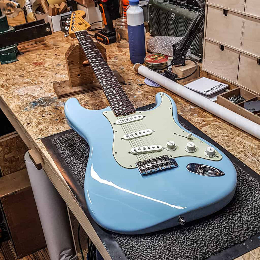 daphne blue guitar laying down