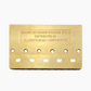 gold back side of 5-string bass bridge with grooved saddles