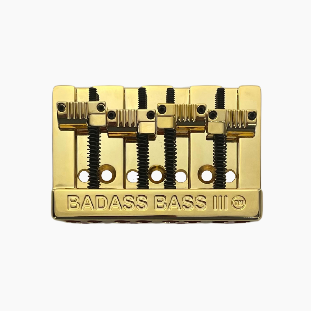 angled front view of gold 4-string bass bridge version 3 with grooved saddles