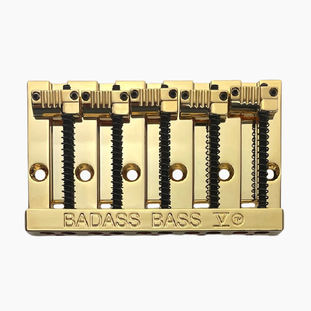gold front view of 5-string bass bridge with grooved saddles
