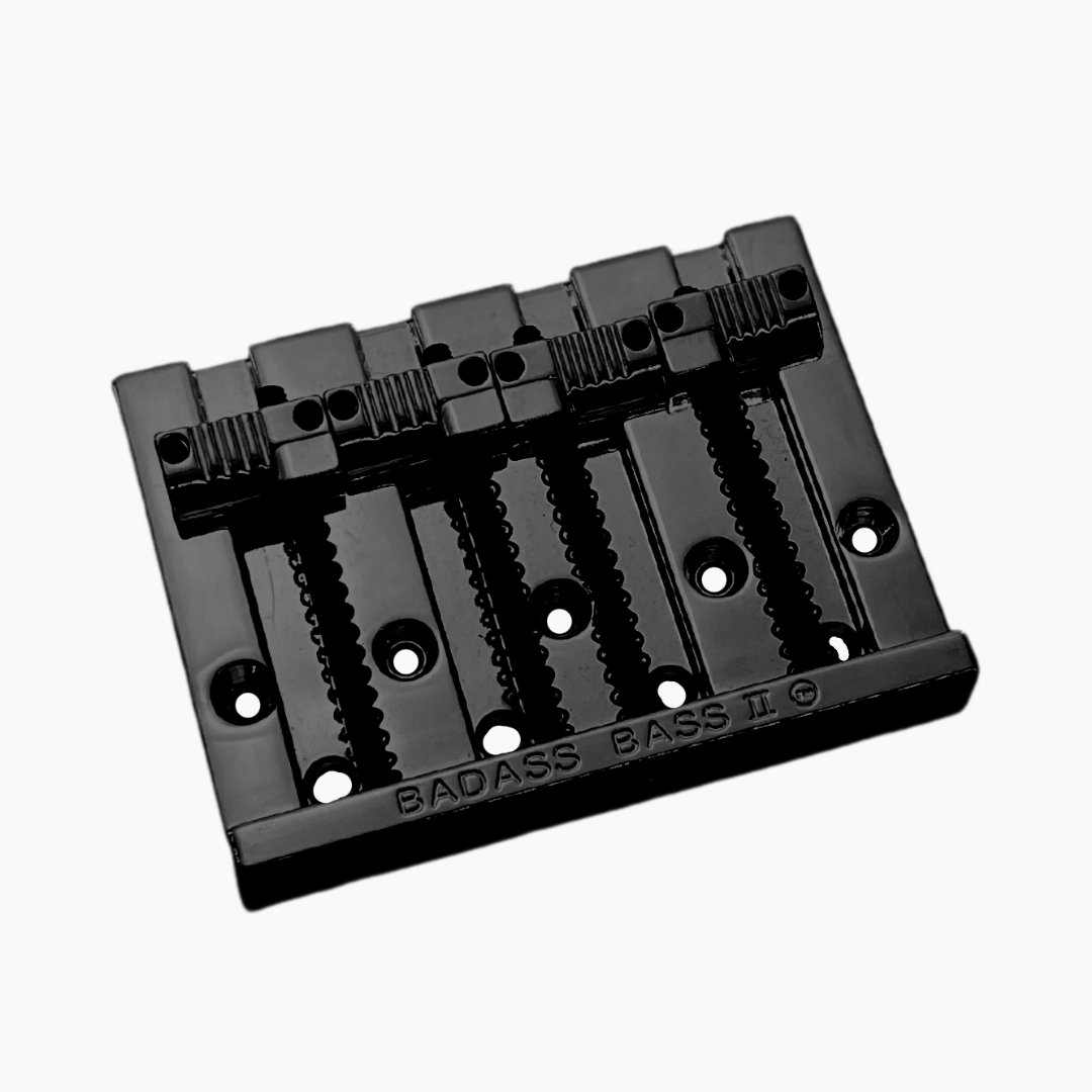 angled front view black 4-string bass bridge with  grooved saddles