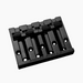 angled front view black 4-string bass bridge with  grooved saddles